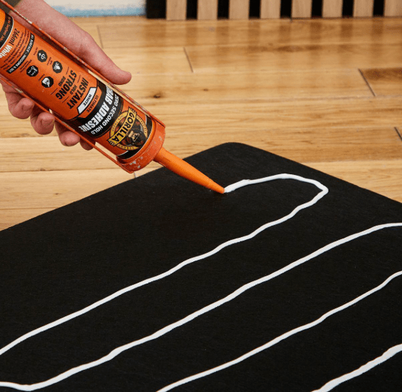 How to use grab adhesives? Contractor applying beads of high grab adhesive with a caulking gun